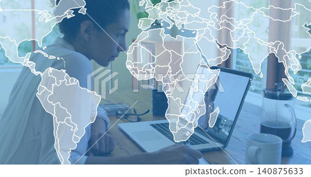 Leaning woman writing on notebook in light blouse at home desk, using laptop with map overlay Leaning woman writing on notebook in light blouse at home desk, using laptop with map overlay 140875633