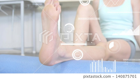 Extending woman showing bare foot and lower leg on blue mat in clinic, wearing gray-shorts, HUD Extending woman showing bare foot and lower leg on blue mat in clinic, wearing gray-shorts, HUD 140875701
