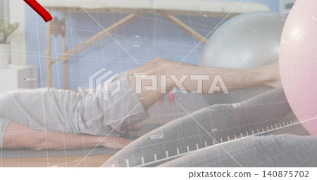 Doing core exercise woman with partner using pink ball in studio, in leggings, shorts, overlay Doing core exercise woman with partner using pink ball in studio, in leggings, shorts, overlay 140875702