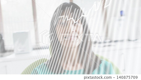 Sitting woman wearing teal top and eyeglasses gazing in office, with green chair and blinds overlay 140875709