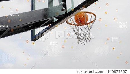 Sinking orange basketball through metal rim net support arm and icons at outdoor court, copy space Sinking orange basketball through metal rim net support arm and icons at outdoor court, copy space 140875867