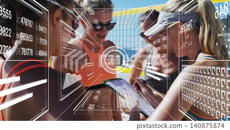 Planning, four athletes in tanks leaning over clipboard or tablet at sand court, yellow net, HUD dat Planning, four athletes in tanks leaning over clipboard or tablet at sand court, yellow net, HUD dat 140875874