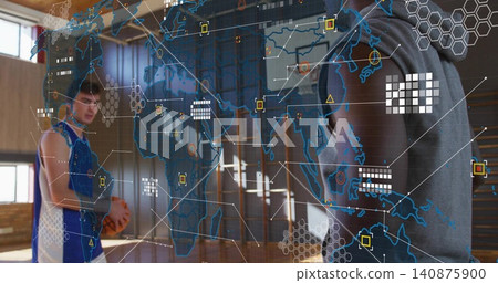 Pointing at data overlay, hooded coach guiding player in jersey holding basketball on court Pointing at data overlay, hooded coach guiding player in jersey holding basketball on court 140875900