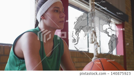 Sitting female wearing green jersey and white headband on gym bench, basketball by knees, AR globe Sitting female wearing green jersey and white headband on gym bench, basketball by knees, AR globe 140875923