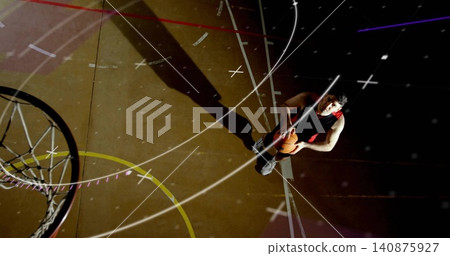 Standing basketball player in sleeveless jersey holding ball near hoop with painted lines Standing basketball player in sleeveless jersey holding ball near hoop with painted lines 140875927