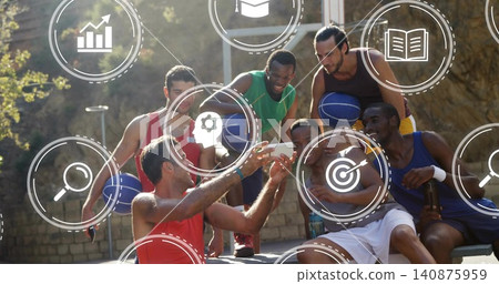 Taking selfie, six men at court holding phone and blue basketballs, wearing tanks, icons overlaying Taking selfie, six men at court holding phone and blue basketballs, wearing tanks, icons overlaying 140875959