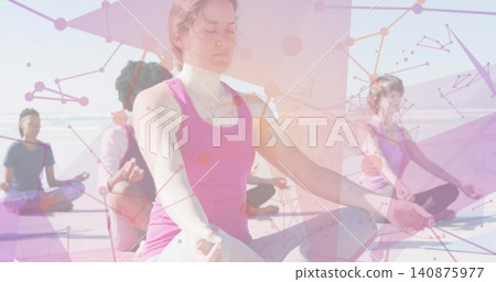 Meditating front woman in pink tank and leggings on sandy beach, yoga mats, ocean, network overlay Meditating front woman in pink tank and leggings on sandy beach, yoga mats, ocean, network overlay 140875977