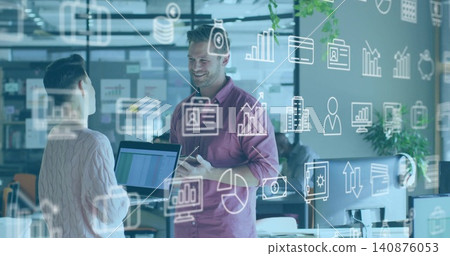 Smiling pink-shirt man holding phone and woman holding laptop, talking at office, data overlay Smiling pink-shirt man holding phone and woman holding laptop, talking at office, data overlay 140876053