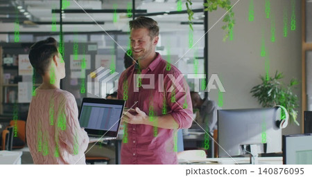 Smiling man in pink shirt holding smartphone and showing laptop spreadsheet at open-plan office Smiling man in pink shirt holding smartphone and showing laptop spreadsheet at open-plan office 140876095