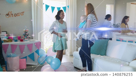 Smiling pregnant woman cradling belly in living room, wearing mint dress and cardigan with balloons Smiling pregnant woman cradling belly in living room, wearing mint dress and cardigan with balloons 140876255