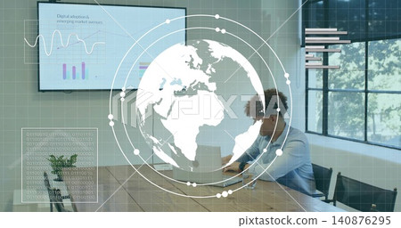 Working adult male wearing blue shirt on laptop at conference table, monitors, overlays, copy space Working adult male wearing blue shirt on laptop at conference table, monitors, overlays, copy space 140876295