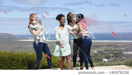 Laughing women holding infant and hugging on stone terrace, wearing mint dress and striped top Laughing women holding infant and hugging on stone terrace, wearing mint dress and striped top 140876298