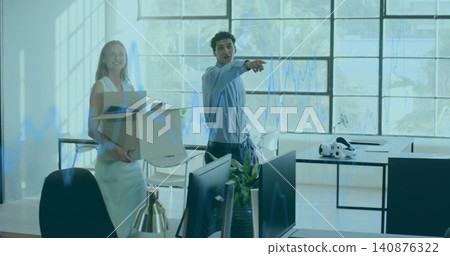 Pointing man in blue shirt directing loft setup, co-worker in white dress holding box laptop VR Pointing man in blue shirt directing loft setup, co-worker in white dress holding box laptop VR 140876322