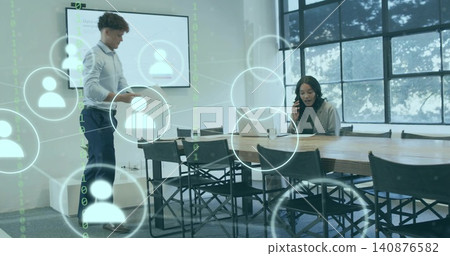 Presenting man holding tablet near screen, woman in blazer calling at meeting table with overlay 140876582