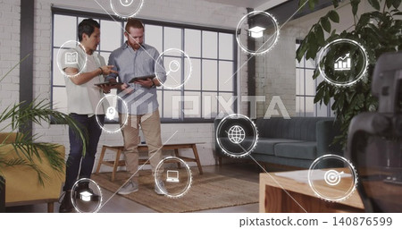 Reviewing tablets, colleagues in white blouse and blue shirt studying HUD icons in loft, copy space Reviewing tablets, colleagues in white blouse and blue shirt studying HUD icons in loft, copy space 140876599