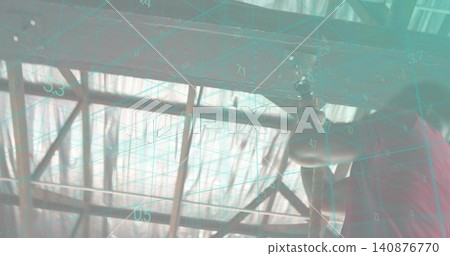 Reaching man wearing red shirt checking metal trusses in hangar, with teal grid overlay, copy space Reaching man wearing red shirt checking metal trusses in hangar, with teal grid overlay, copy space 140876770