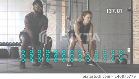 Lifting two fit adults wearing workout gear performing kettlebell deadlifts at gym, with overlay Lifting two fit adults wearing workout gear performing kettlebell deadlifts at gym, with overlay 140876779