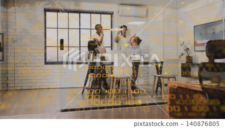 High-fiving team of four in businesswear in glass meeting room with laptops, data overlay 140876805