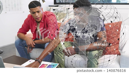 Pointing, man in red shirt leaning over sofa at office lounge, examining laptop swatches overlay Pointing, man in red shirt leaning over sofa at office lounge, examining laptop swatches overlay 140876816