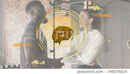 Coaching trainer guiding client at gym, wearing dark workout shirt and light hoodie, HUD brain Coaching trainer guiding client at gym, wearing dark workout shirt and light hoodie, HUD brain 140876819