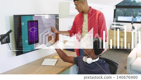 Pointing red shirt, colleague in navy tee with white headset reaching display in office with tablet Pointing red shirt, colleague in navy tee with white headset reaching display in office with tablet 140876900