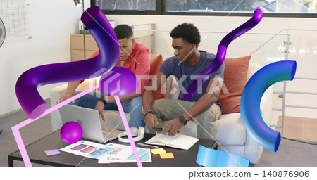 Working two men wearing red hoodie blue tee in loft reviewing laptop notebook swatches AR overlays Working two men wearing red hoodie blue tee in loft reviewing laptop notebook swatches AR overlays 140876906