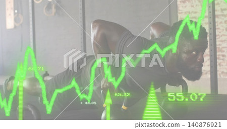 Holding kettlebells, athlete holding plank at warehouse gym, wearing dark shirt, neon graph overlay Holding kettlebells, athlete holding plank at warehouse gym, wearing dark shirt, neon graph overlay 140876921