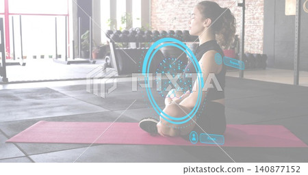 Sitting adult in black clothes meditating on pink-mat at gym with blue AR overlay, copy space Sitting adult in black clothes meditating on pink-mat at gym with blue AR overlay, copy space 140877152