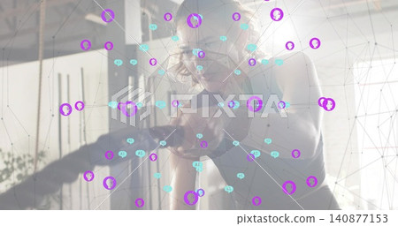 Leaning woman wearing glasses and tank top checking phone in studio, plant slats network overlay Leaning woman wearing glasses and tank top checking phone in studio, plant slats network overlay 140877153