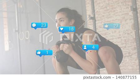 Doing kettlebell goblet squat, woman in black gear gripping kettlebell at gym, with reaction icons Doing kettlebell goblet squat, woman in black gear gripping kettlebell at gym, with reaction icons 140877155