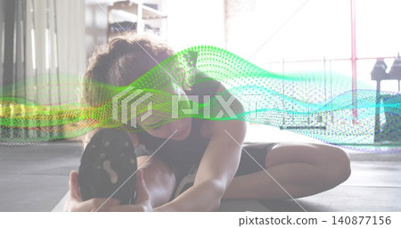 Stretching woman in dark tank, black shorts reaching foot on mat with shoe, dotted wave overlay Stretching woman in dark tank, black shorts reaching foot on mat with shoe, dotted wave overlay 140877156