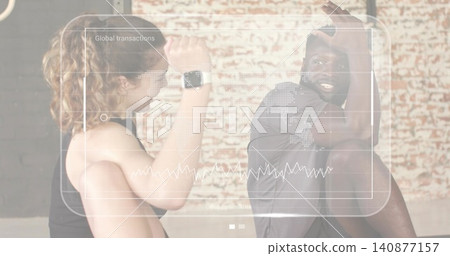 Pair raising forearms by brick wall in gear with smartwatch and Global transactions map chart Pair raising forearms by brick wall in gear with smartwatch and Global transactions map chart 140877157
