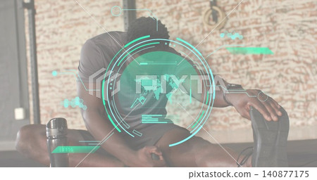 Stretching man in dark athletic gear reaching forward on fitness studio mat, with teal HUD 140877175