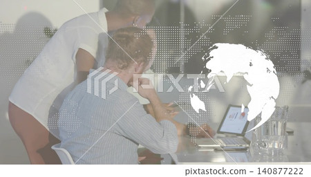 Leaning team in office shirts studying laptop chart at glass table, dotted map overlay, pitcher 140877222