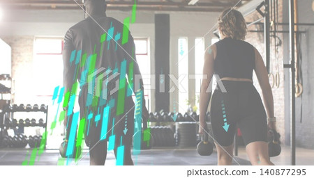 Holding kettlebells, training partners in gym gear walking in warehouse gym with rigs and overlays Holding kettlebells, training partners in gym gear walking in warehouse gym with rigs and overlays 140877295