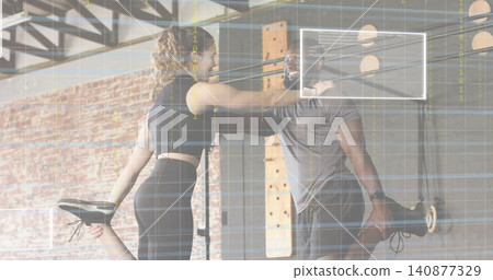 Balancing two partners doing quad stretch in warehouse gym, wearing athletic clothing, grid lines Balancing two partners doing quad stretch in warehouse gym, wearing athletic clothing, grid lines 140877329