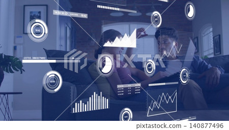 Sitting couple, woman in pink top, man holding tablet, on sofa at home, viewing AR overlays Sitting couple, woman in pink top, man holding tablet, on sofa at home, viewing AR overlays 140877496