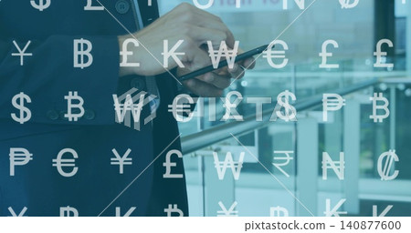 Tapping man in navy suit light shirt using smartphone in office atrium, currency symbols overlay Tapping man in navy suit light shirt using smartphone in office atrium, currency symbols overlay 140877600