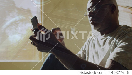 Holding phone, senior man leaning by blinds at home, wearing glasses, wedding ring, showing HUD Holding phone, senior man leaning by blinds at home, wearing glasses, wedding ring, showing HUD 140877636