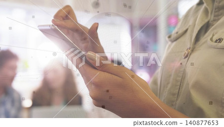 Holding smartphone, adult woman tapping screen during office meeting, wearing button shirt Holding smartphone, adult woman tapping screen during office meeting, wearing button shirt 140877653