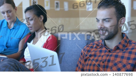 Working three coworkers in casual clothes sitting on sofa in office, with laptops, numeric overlays Working three coworkers in casual clothes sitting on sofa in office, with laptops, numeric overlays 140877698