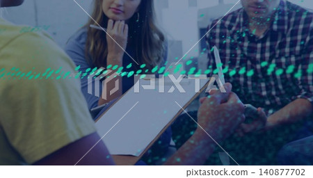 Discussing group in yellow, plaid shirts leaning over clipboard in meeting room, with teal overlay 140877702