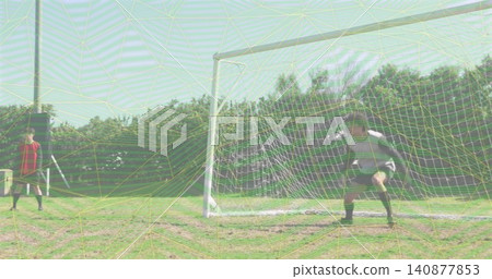 Standing keeper in striped jersey guarding goal on grassy pitch, with painted lines and white net Standing keeper in striped jersey guarding goal on grassy pitch, with painted lines and white net 140877853