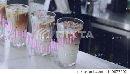 Showing three tall clear iced coffee glasses condensing on marble counter, projecting stock charts Showing three tall clear iced coffee glasses condensing on marble counter, projecting stock charts 140877902