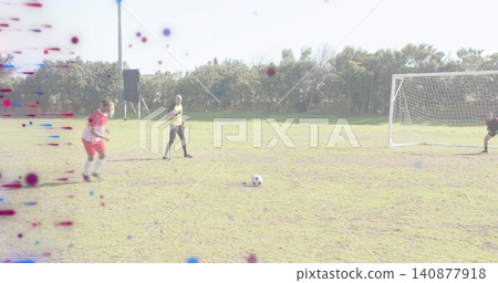 Running outfield player in red kit moving toward soccer ball on grassy pitch, yellow bib, speaker Running outfield player in red kit moving toward soccer ball on grassy pitch, yellow bib, speaker 140877918