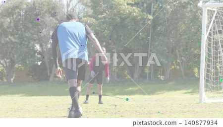 Stepping player in blue bib approaching soccer ball on grass pitch, keeper with gloves, copy space Stepping player in blue bib approaching soccer ball on grass pitch, keeper with gloves, copy space 140877934