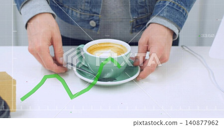 Placing hands in denim sleeves holding green cup with teaspoon on tabletop, showing trend overlay 140877962