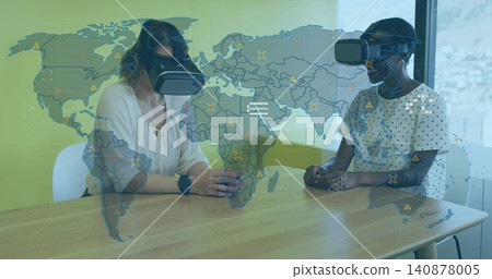 Testing VR two women wearing headsets, light blouse, dotted tee, watch, in demo room, world-map HUD Testing VR two women wearing headsets, light blouse, dotted tee, watch, in demo room, world-map HUD 140878005