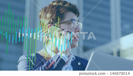 Talking mature Asian man wearing navy blazer, glasses holding laptop and phone in plaza, waveform Talking mature Asian man wearing navy blazer, glasses holding laptop and phone in plaza, waveform 140878014