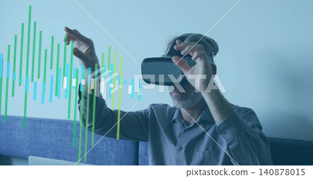Manipulating mature man wearing gray shirt on blue sofa, using VR-headset, laptop, data-overlay Manipulating mature man wearing gray shirt on blue sofa, using VR-headset, laptop, data-overlay 140878015